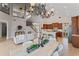 Open-concept living space showcasing chandelier, high ceilings, staircase, and adjacent kitchen at 4306 Barracuda Dr, Bradenton, FL 34208