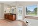 Spacious bathroom featuring double sinks, granite counters, large mirror, soaking tub and pool access at 4306 Barracuda Dr, Bradenton, FL 34208