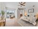 Spacious bedroom suite with sitting area, neutral palette, ceiling fan and ample natural light at 4306 Barracuda Dr, Bradenton, FL 34208