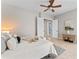 Spacious bedroom suite with sitting area, neutral palette, ceiling fan and ample natural light at 4306 Barracuda Dr, Bradenton, FL 34208