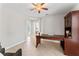 A spacious office room with a large wooden desk, arched doorways, and tile flooring at 4306 Barracuda Dr, Bradenton, FL 34208
