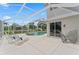 Screened-in pool area with lounge chairs and a view of the well-manicured backyard and tropical landscaping at 4306 Barracuda Dr, Bradenton, FL 34208