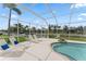 A serene pool area featuring lounge chairs, landscaping and canal views, all enclosed by a screen at 4306 Barracuda Dr, Bradenton, FL 34208