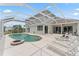 View of the home from a backyard pool area, including an outdoor kitchen and multiple seating areas at 4306 Barracuda Dr, Bradenton, FL 34208