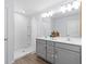 Bathroom with double sink vanity, modern fixtures, and a walk-in shower at 4312 E Shadowlawn Ave, Tampa, FL 33610