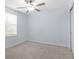 Empty bedroom with a ceiling fan, natural light, and neutral carpet at 4312 E Shadowlawn Ave, Tampa, FL 33610