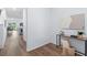 Hallway featuring wood floors and a console table with decor and white walls at 4312 E Shadowlawn Ave, Tampa, FL 33610