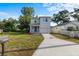 Front exterior view of the two-story home with attached garage, blue doors and a freshly landscaped yard at 4312 E Shadowlawn Ave, Tampa, FL 33610