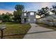 Charming two-story home featuring a well-maintained lawn and a modern color scheme at sunset at 4312 E Shadowlawn Ave, Tampa, FL 33610