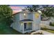 Charming two-story home with a light blue exterior, covered porch, and well-maintained landscaping at 4312 E Shadowlawn Ave, Tampa, FL 33610