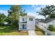 Two-story home with a well-manicured front yard, driveway, and inviting blue front door at 4312 E Shadowlawn Ave, Tampa, FL 33610