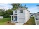 This two-story home has a blue front door, white exterior and attached garage at 4312 E Shadowlawn Ave, Tampa, FL 33610