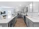 Modern kitchen with stainless steel appliances, quartz countertops, and wood flooring at 4312 E Shadowlawn Ave, Tampa, FL 33610