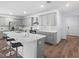 Modern kitchen featuring an island with seating, white countertops, and stainless steel appliances at 4312 E Shadowlawn Ave, Tampa, FL 33610