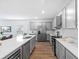 Modern kitchen with stainless steel appliances, quartz countertops, and wood flooring at 4312 E Shadowlawn Ave, Tampa, FL 33610