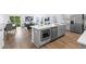 Open-concept kitchen with stainless steel appliances and a large island, seamlessly connecting to the living area at 4312 E Shadowlawn Ave, Tampa, FL 33610