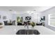 Open floor plan featuring the kitchen and living room with stainless sink and stylish decor at 4312 E Shadowlawn Ave, Tampa, FL 33610