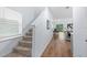 Carpeted stairs with a window and a view into the kitchen, dining area, and living area at 4312 E Shadowlawn Ave, Tampa, FL 33610