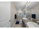 Modern bathroom with double sinks, granite countertop, and a tiled shower at 4504 Silver Lining St, Sarasota, FL 34238