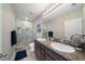 Modern bathroom featuring double sinks, granite countertops, and a tiled shower at 4504 Silver Lining St, Sarasota, FL 34238