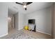 Bedroom featuring a window with view, a ceiling fan, a tv, grey walls and beige carpeting at 4504 Silver Lining St, Sarasota, FL 34238