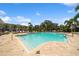Inviting community pool with clear blue water, surrounded by lush landscaping and ample seating for residents to enjoy at 4504 Silver Lining St, Sarasota, FL 34238