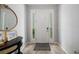 Bright entryway featuring tile flooring, a console table with mirror, and a welcoming front door with sidelights at 4504 Silver Lining St, Sarasota, FL 34238
