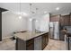 Well-lit kitchen featuring a large island, stainless steel appliances, and granite countertops at 4504 Silver Lining St, Sarasota, FL 34238