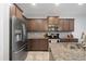 Well-equipped kitchen featuring stainless steel appliances, tile backsplash, and granite countertops at 4504 Silver Lining St, Sarasota, FL 34238