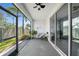 Cozy screened lanai with seating, plants, a ceiling fan, and a view of the backyard at 4504 Silver Lining St, Sarasota, FL 34238