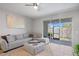 Comfortable living room with a sectional sofa and sliding glass doors leading to an outdoor patio at 4504 Silver Lining St, Sarasota, FL 34238