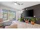 Bright living room with a large television, backyard access, and neutral decor at 4504 Silver Lining St, Sarasota, FL 34238