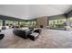 Spacious lounge area featuring a stone fireplace, plush seating, and a bright, airy ambiance with views of the outdoors at 4504 Silver Lining St, Sarasota, FL 34238