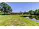 Large backyard with view of pond and screened in patio at 50 Ingrid Pl # 50, Oldsmar, FL 34677