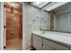 The full bathroom with white vanity and shower stall is well lit and spacious at 50 Ingrid Pl # 50, Oldsmar, FL 34677