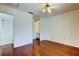 Hardwood bedroom featuring an en suite bathroom and a ceiling fan at 50 Ingrid Pl # 50, Oldsmar, FL 34677