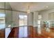 Bright dining area with hardwood floors, modern chandelier, and sliding glass doors to the outside patio at 50 Ingrid Pl # 50, Oldsmar, FL 34677