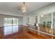 Bright dining area with hardwood floors, modern chandelier, and sliding glass doors to the outside patio at 50 Ingrid Pl # 50, Oldsmar, FL 34677