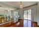 Bright dining area with hardwood floors, modern chandelier, and mirrored wall at 50 Ingrid Pl # 50, Oldsmar, FL 34677