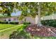 Single-story home with inviting walkway, manicured landscaping, and mature shade tree in yard at 50 Ingrid Pl # 50, Oldsmar, FL 34677
