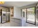 Bright kitchen with white tile floors, island, and stainless steel refrigerator at 50 Ingrid Pl # 50, Oldsmar, FL 34677