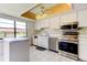 Bright kitchen with white cabinets, island, and stainless steel appliances at 50 Ingrid Pl # 50, Oldsmar, FL 34677