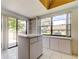 Eat-in kitchen area with built-in shelving and cabinets and sliding glass door access at 50 Ingrid Pl # 50, Oldsmar, FL 34677