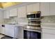Clean kitchen featuring stainless steel oven, microwave and dishwasher, and white cabinets at 50 Ingrid Pl # 50, Oldsmar, FL 34677