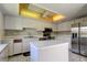 Bright kitchen with white cabinets, island, and stainless steel appliances at 50 Ingrid Pl # 50, Oldsmar, FL 34677