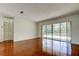Open living room featuring hardwood floors and sliding glass doors providing view of screened patio at 50 Ingrid Pl # 50, Oldsmar, FL 34677