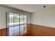 Living room showcasing hardwood floors and sliding glass doors providing view of the screened patio at 50 Ingrid Pl # 50, Oldsmar, FL 34677