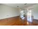 Living room featuring hardwood floors, stylish lighting fixtures and access to the backyard at 50 Ingrid Pl # 50, Oldsmar, FL 34677