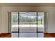 Living room with sliding glass doors to a screened in porch overlooking a lake at 50 Ingrid Pl # 50, Oldsmar, FL 34677