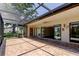 A large, screened-in patio with brick flooring offers space for outdoor entertaining at 50 Ingrid Pl # 50, Oldsmar, FL 34677